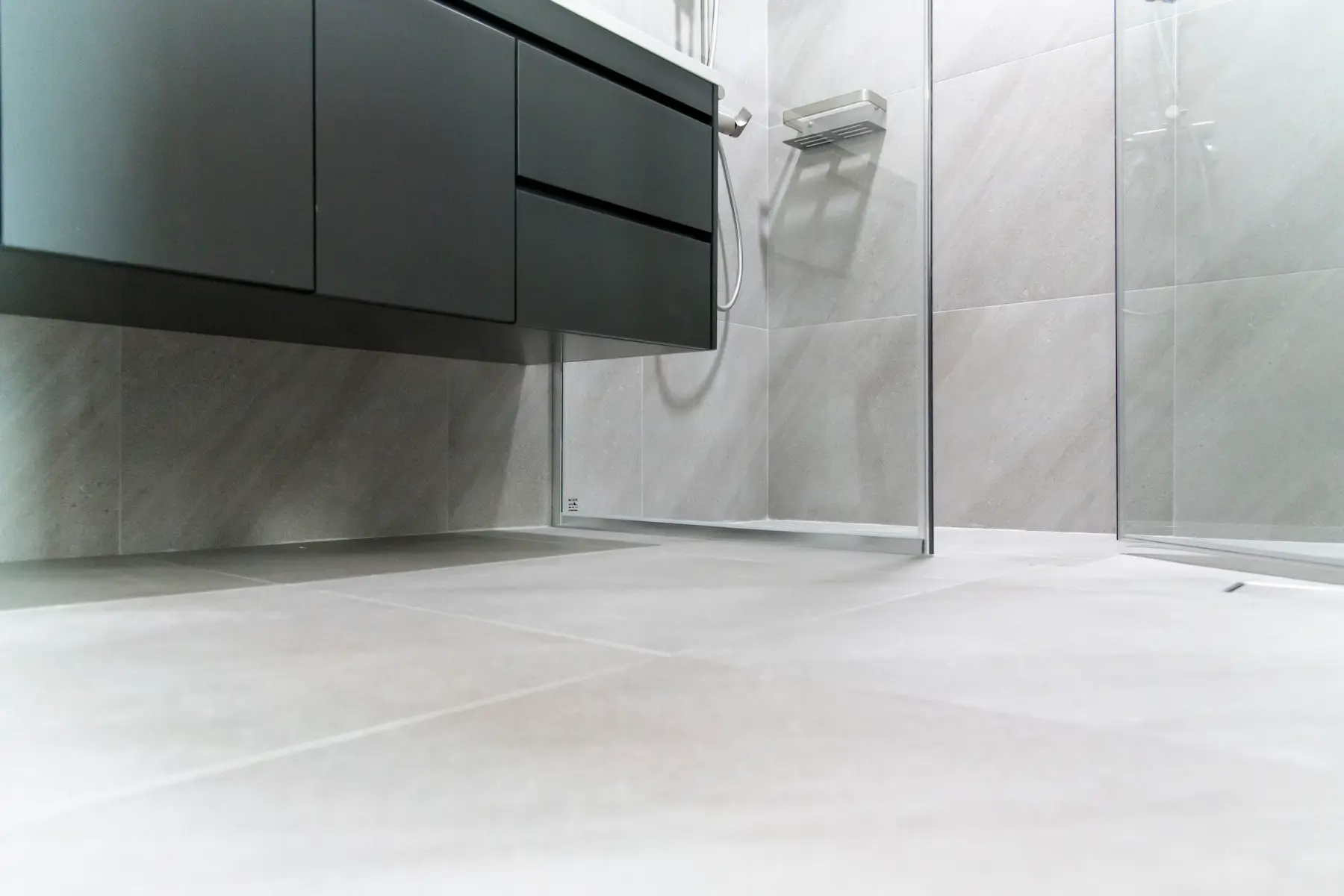 Modern bathroom interior with tile flooring showing professional leak repair work