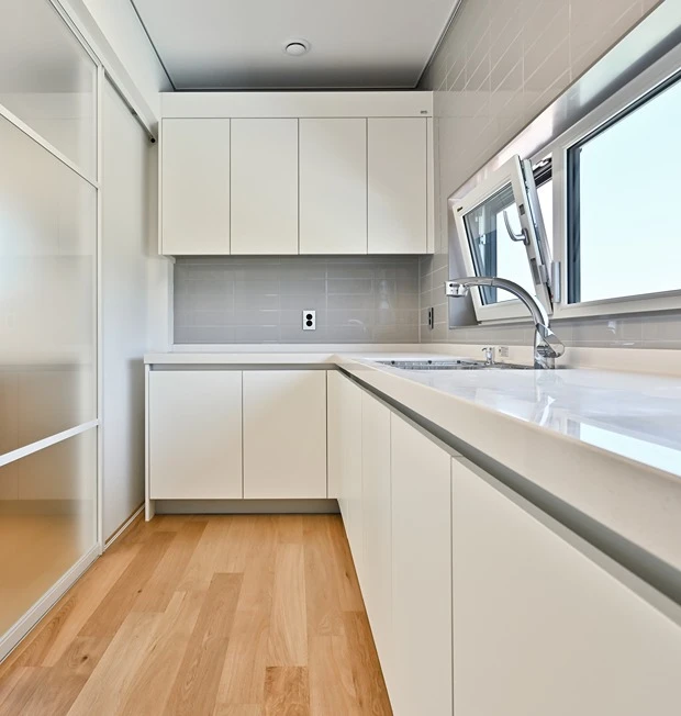 Professional kitchen renovation showing splashback waterproofing work